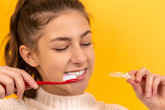 A young woman considers popular cosmetic dentistry treatments