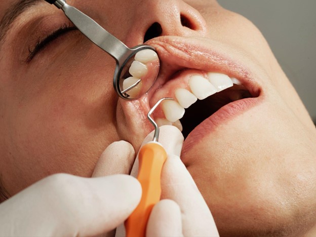 Alt text: Woman receives top-tier dental care with a dentist in Oakbrook Terrace, IL