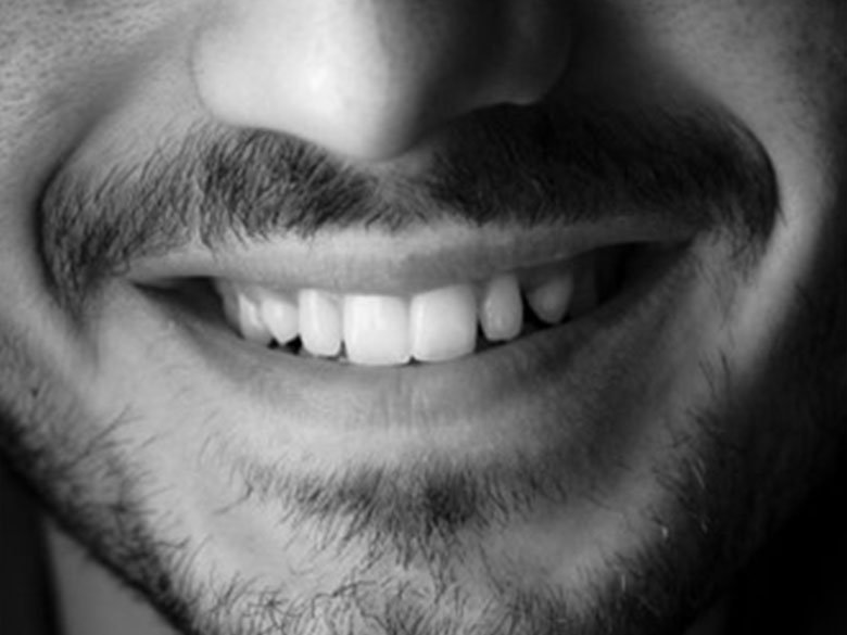 A picture of a person’s nose and smiling mouth