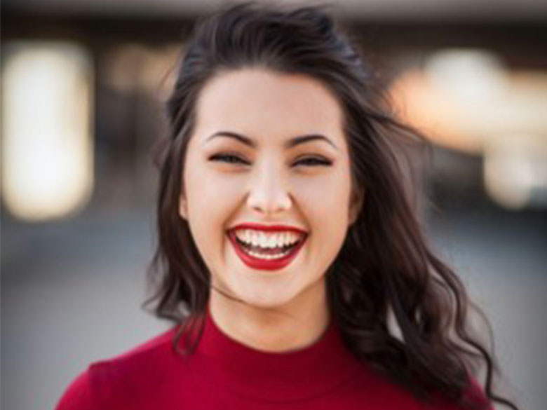 A young woman smiles widely, displaying the advantages of dental bonding in Oakbrook Terrace, IL