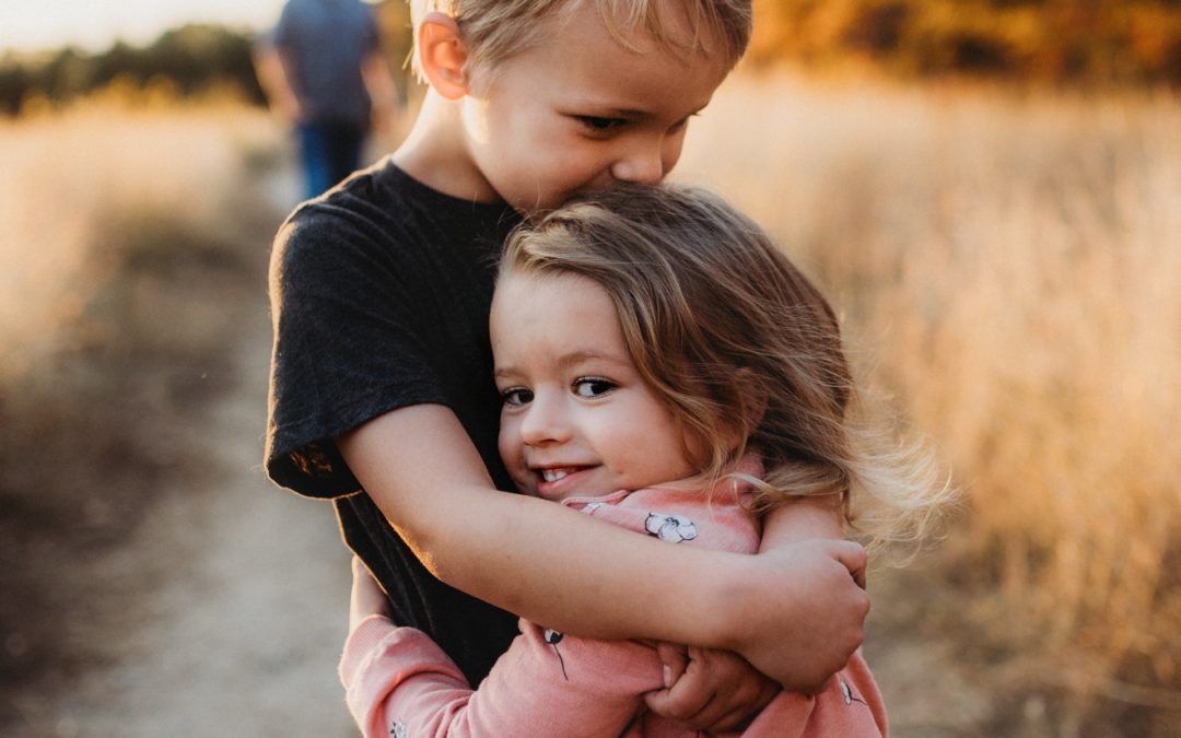 Two children embrace after visiting a children's dentist in Oakbrook Terrace, IL